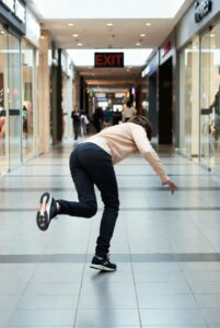 Woman tripping in mall.