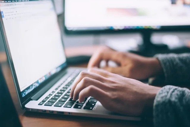 Person doing work on a computer.