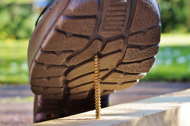 Person stepping on nail