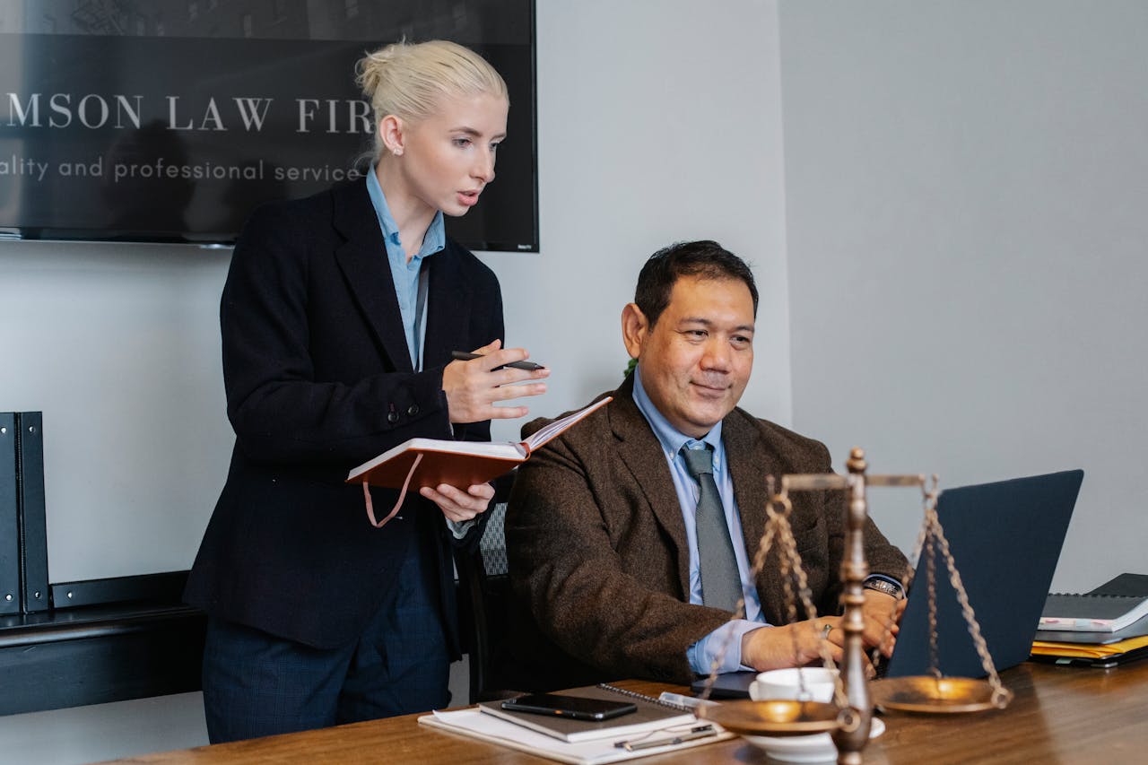 Man and woman looking at laptop.