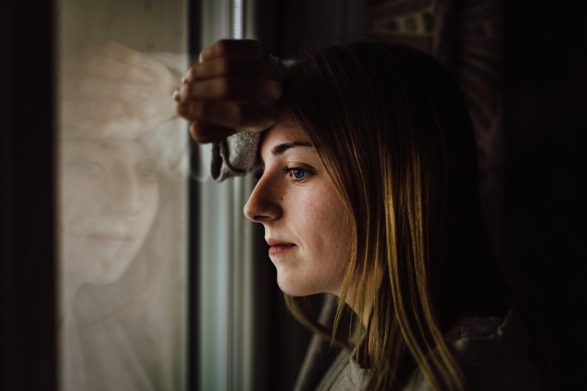 Lady looking out window.